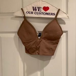 A tan crop top from Dazy and O/S - is padded